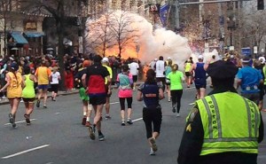Boston Marathon Bombing Runners continue to run towards the finish line as an explosion erupts at the finish line of the Boston Marathon