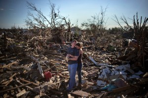 Tornado in Moore, OK Danielle Stephan holds boyfriend Thomas Layton as they pause between salvaging through the remains of a family member's home one day after a tornado devastated the town Moore, Oklahoma