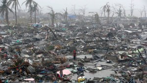 Super Typhoon Haiyan in the Philippines Survivors stand among debris and ruins of houses destroyed after Super Typhoon Haiyan battered Tacloban city in central Philippines